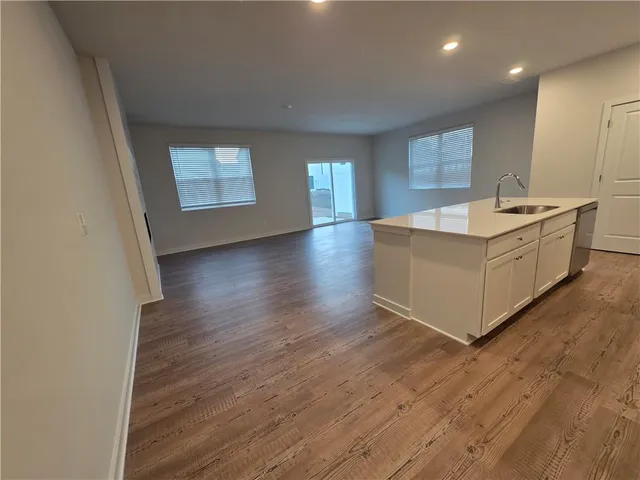 a view of a kitchen counter top space with wooden floor