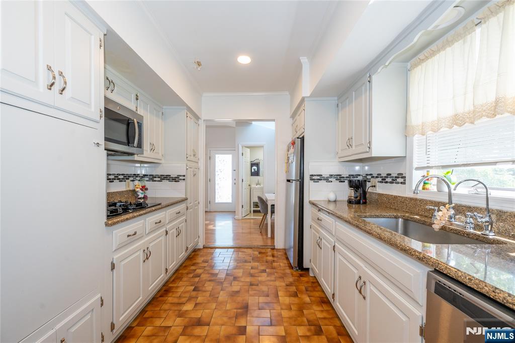 690 Garden Street Maywood, NJ 07607 - Photo 13 of 49 a large kitchen with stainless steel appliances granite countertop a lot of counter space and a sink