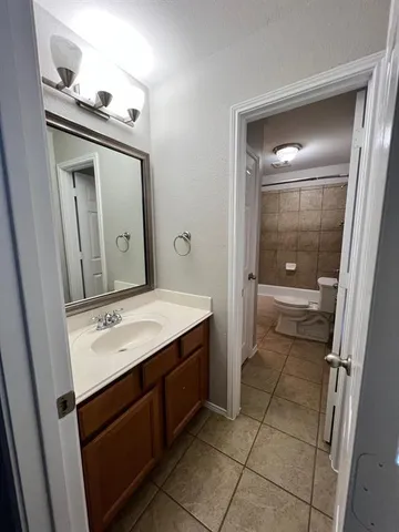 a bathroom with a sink a toilet and mirror
