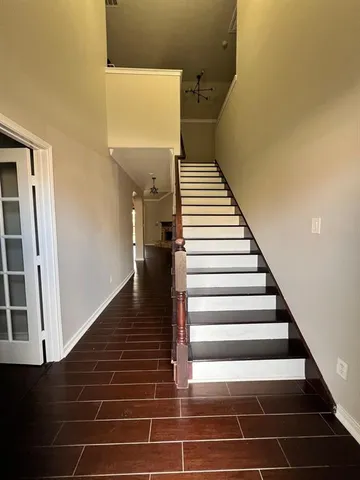 a view of entryway and hall with wooden floor