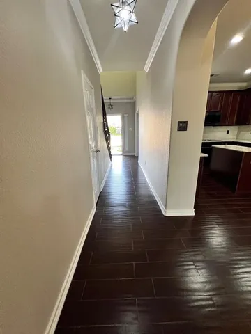a view of a hallway with wooden floor