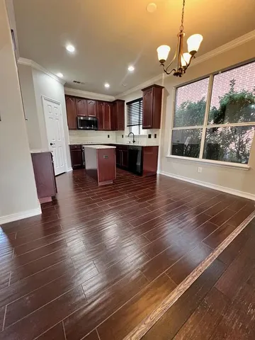 a open kitchen view with stainless steel appliances granite countertop a stove and cabinets