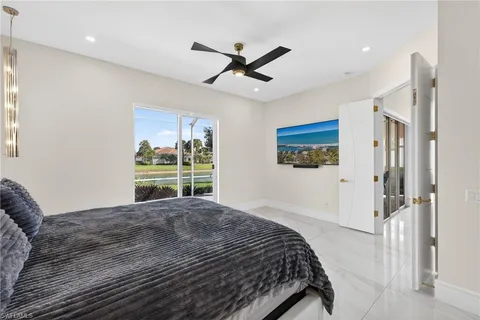 a bedroom with a bed and a large window