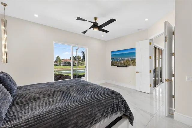 a bedroom with a bed and a large window