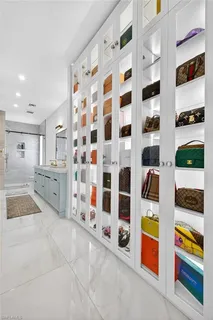 a room with lots of white furniture and shower