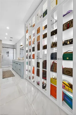 a room with lots of white furniture and shower