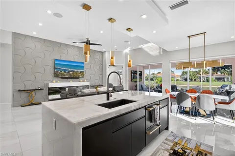 a kitchen with a sink appliances and cabinets