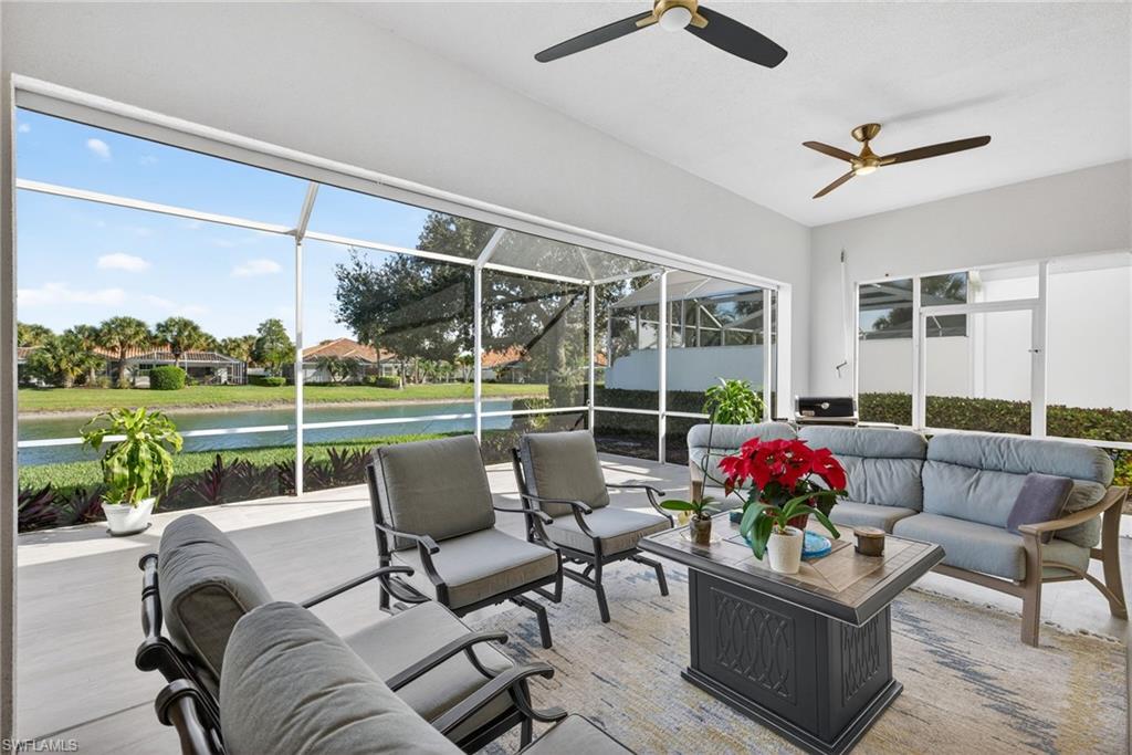 3956 Isla Ciudad Court Naples, FL 34109 - Photo 31 of 39 Sunroom / solarium featuring outdoor lounge area, a water view, a ceiling fan, a patio area, and plenty of natural light