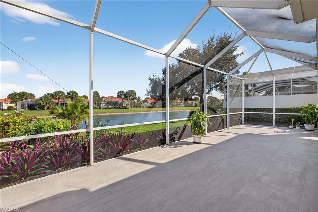 3956 Isla Ciudad Court Naples, FL 34109 - Photo 32 of 39 View of patio / terrace with a water view, a lanai, and a sunroom