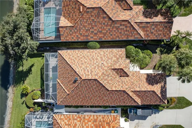 an aerial view of residential houses with outdoor space and river