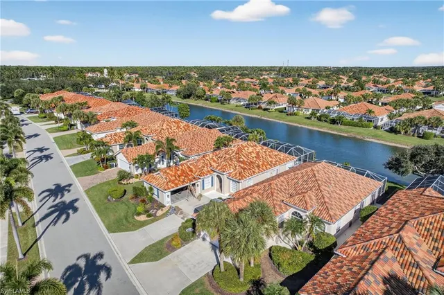 an aerial view of residential houses with outdoor space and river