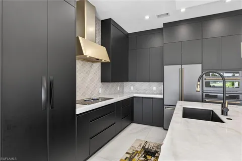 a kitchen with counter top space and stainless steel appliances