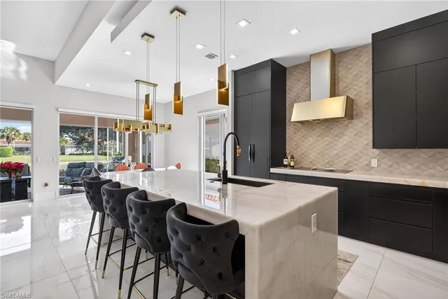a kitchen with a table chairs refrigerator and microwave