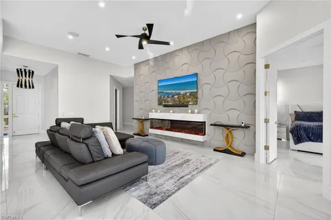 a living room with furniture and kitchen view