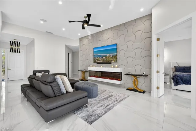 a living room with furniture and kitchen view