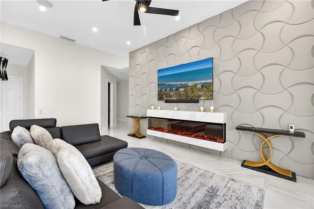 a living room with furniture a ceiling fan and a rug