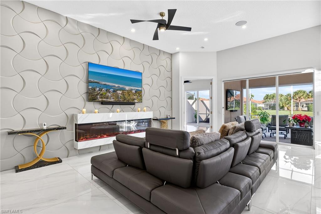 3956 Isla Ciudad Court Naples, FL 34109 - Photo 10 of 39 Living area with an accent wall, wallpapered walls, marble tiled floors, ceiling fan, and recessed lighting