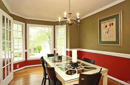Glass french doors lead to DR w/ chair & crown moldings, huge picture window nestled in bay window, hardwoods throughout DR & LR. All trimmed windows w/ lattice detailing & great color choices throughout home. Great room for entertaining.