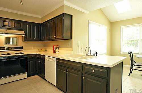 If you like open spaces this is the room for you! Gorgeous light in this room. Deep double sink w/ gooseneck faucet, painted solid wood cabinets, tiled floors, side bar, plenty of space to move about, gas Kenmore stove, brand new Maytag dishwash.