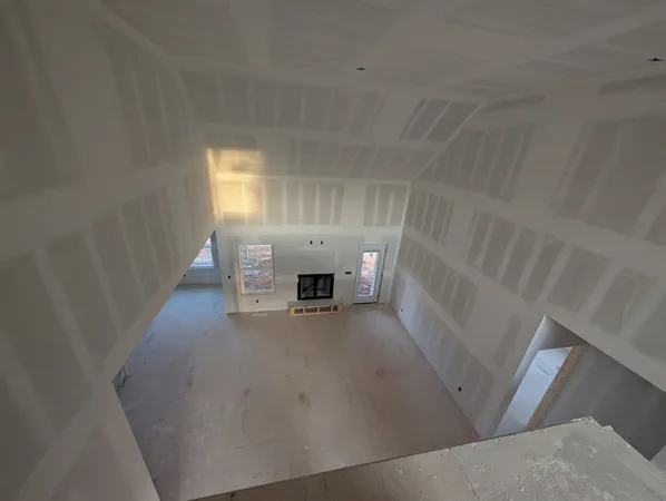 a view of empty room with fireplace and window