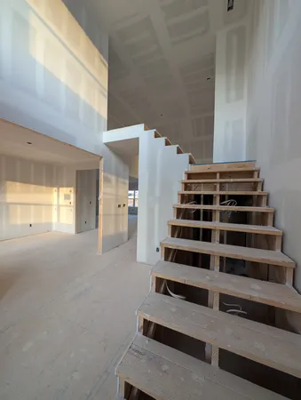 a view of a room with stairs and windows