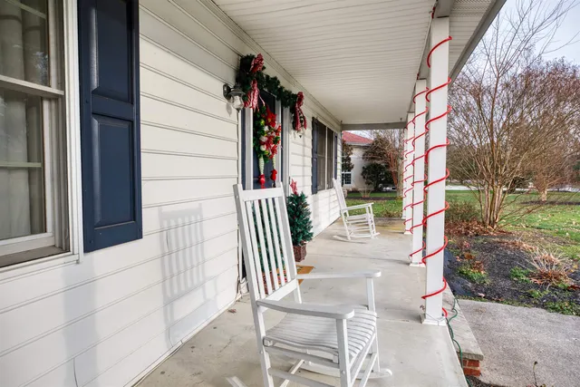 a kitchen with granite countertop a table chairs stove and wooden floor