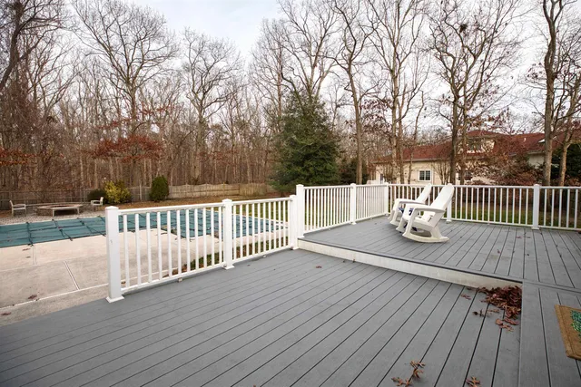 a view of a deck with couches table and chairs with wooden floor