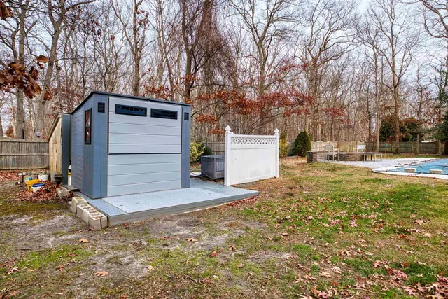 a backyard of apartments with large trees