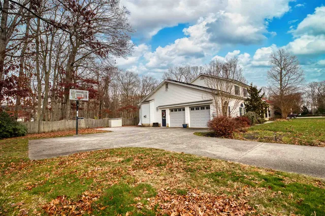a view of a house with a yard covered in snow