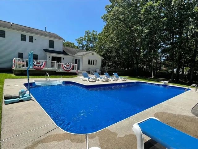 a view of a swimming pool with chairs
