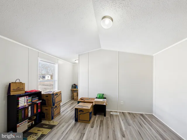 a view of a workspace with furniture and wooden floor