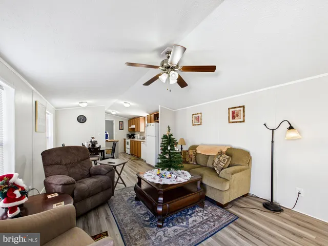 a living room with furniture and a ceiling fan