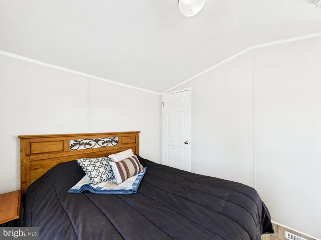 a view of a room with wooden floor and cabinet