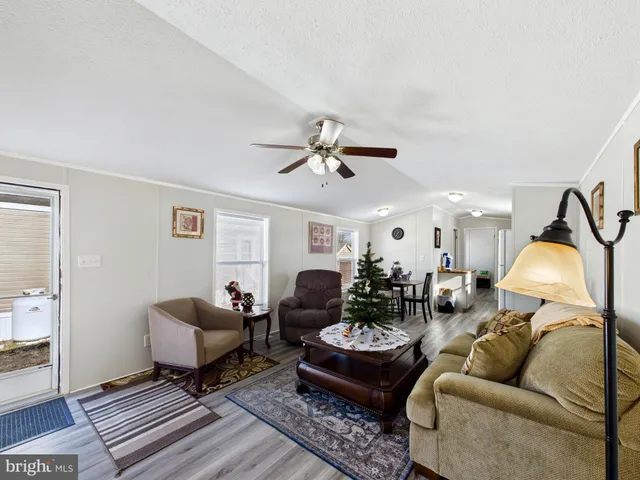 a living room with furniture and a ceiling fan