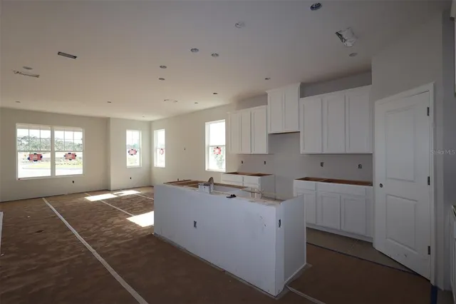 a kitchen with a sink cabinets and window