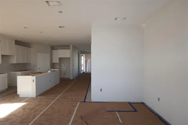 a large white kitchen with a sink