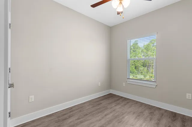 a bedroom with two beds and a painting on the wall