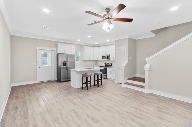 a kitchen with a stove a sink and a refrigerator