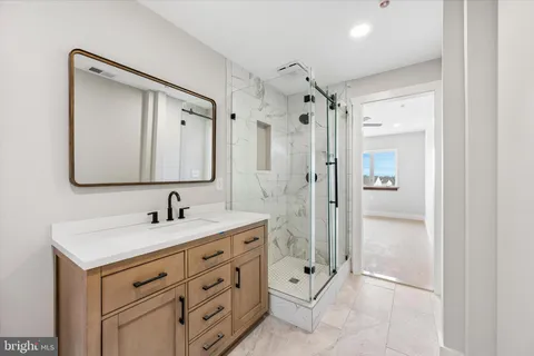 an empty room with a window and a ceiling fan