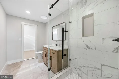 a bathroom with a shower sink and mirror
