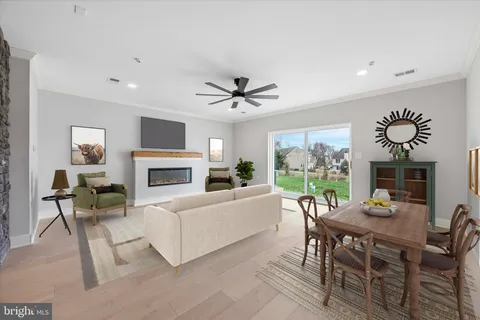 a living room with furniture a fireplace and a table