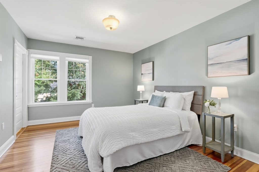 16 Park Avenue, Unit 2 Winchester, MA 01890 - Photo 16 of 32 a bedroom with a bed and wooden floor