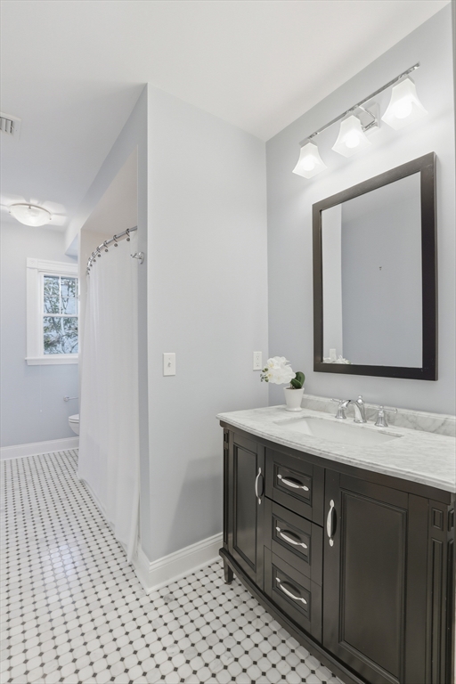 16 Park Avenue, Unit 2 Winchester, MA 01890 - Photo 27 of 32 a bathroom with a sink a mirror and a shower
