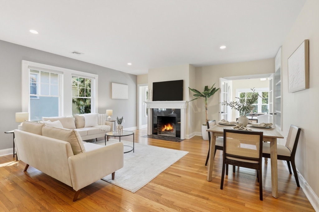 16 Park Avenue, Unit 2 Winchester, MA 01890 - Photo 3 of 32 a living room with furniture a fireplace a flat screen tv and windows