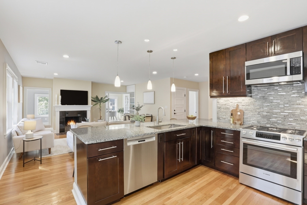 16 Park Avenue, Unit 2 Winchester, MA 01890 - Photo 9 of 32 a open kitchen with stainless steel appliances granite countertop a sink dishwasher stove and oven