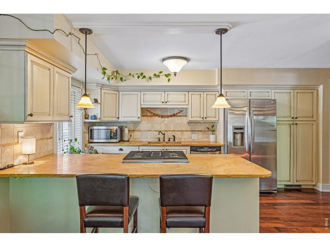 233 North Meldrum Street, Unit 4 Fort Collins, CO 80521 - Photo 6 of 16 a kitchen with a table a stove and cabinets