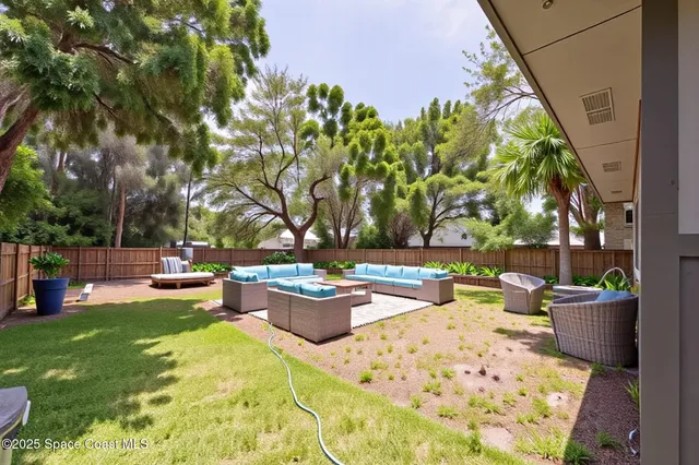 a view of a backyard with sitting area