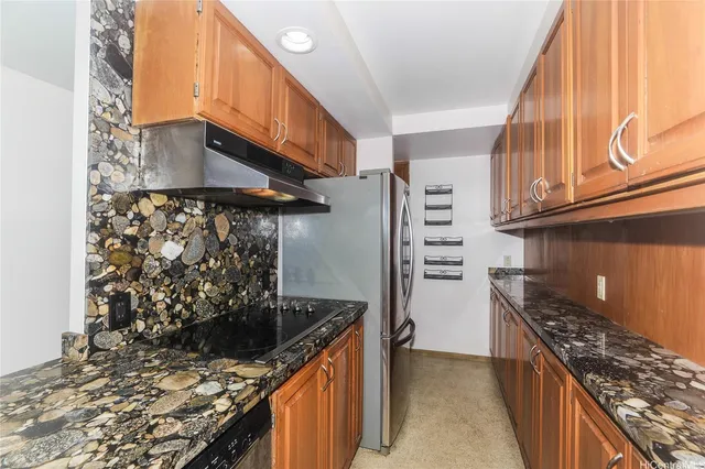 a kitchen with stainless steel appliances granite countertop a stove and a refrigerator