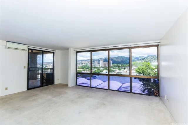 an empty room with large windows