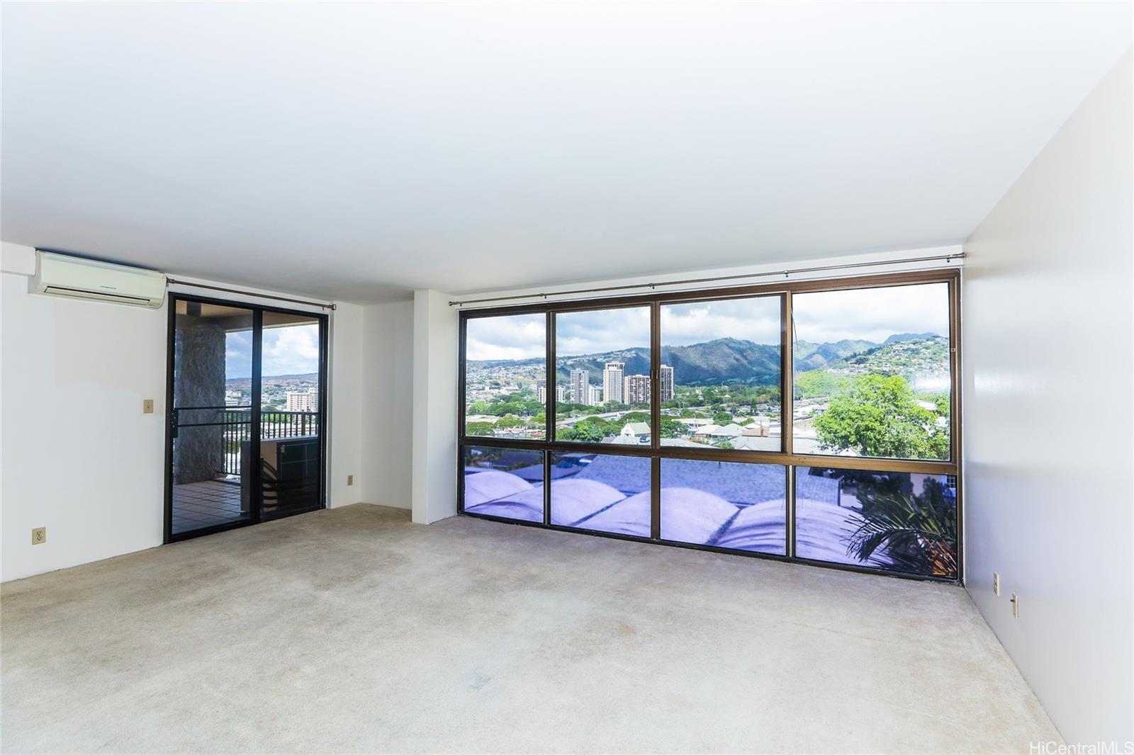 217 Prospect Street, Unit 101 Honolulu, HI 96813 - Photo 4 of 25 an empty room with large windows